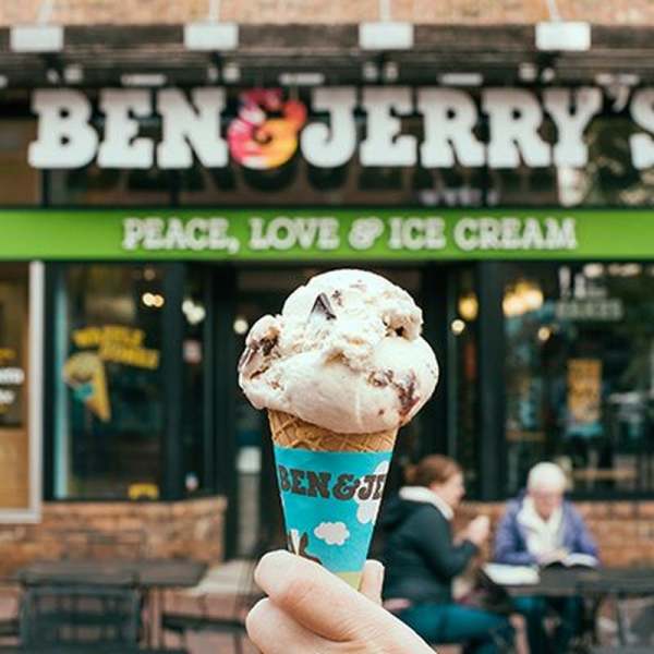 Ben & Jerry's ice cream cone in hand in front of shop
