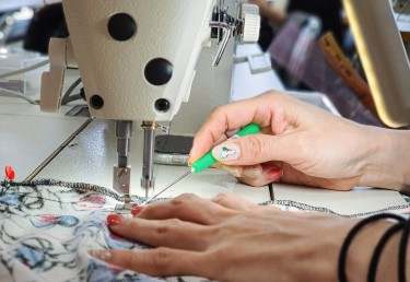 Sewing machine and hands on material