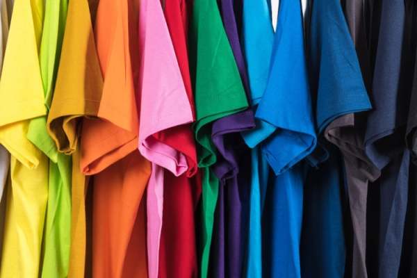 Row of brightly coloured t-shirts viewed side on