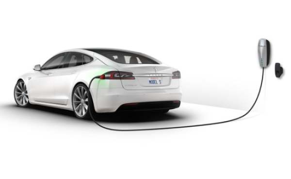 White electric Tesla car plugged in