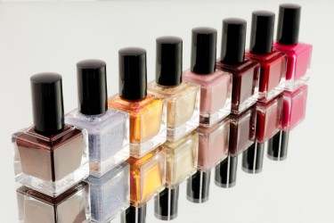 row of bottles of coloured nail varnish