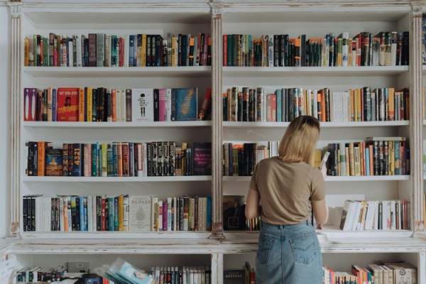 Bookshop shelves with a person browsing the books