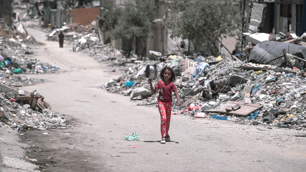 A girl walks through Gaza through rubble during the Israel war