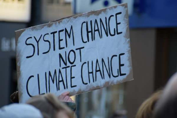 Protest placard 'System change not climate change'