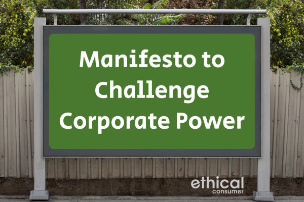 Billboard on street with words 'manifesto to challenge corporate power'